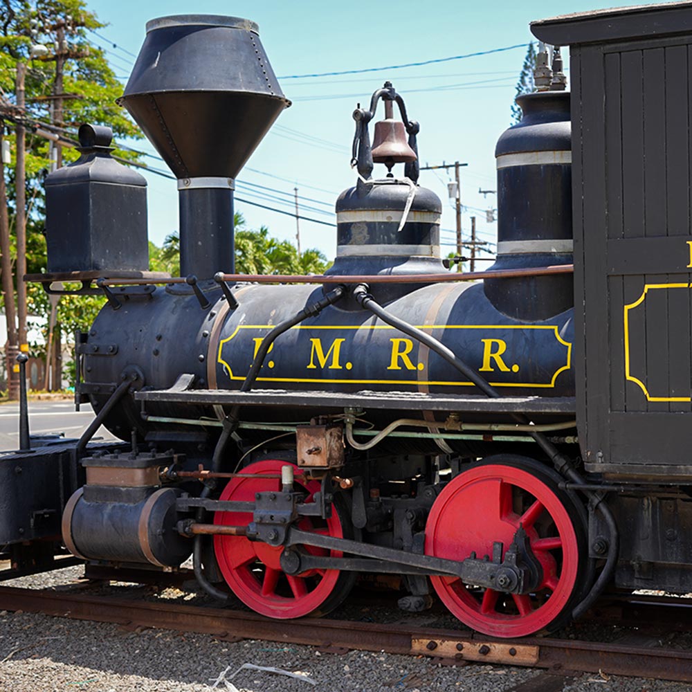 image of historic smokestack and trains in Lahaina.